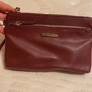 Gently used wristlet. Perfect to carry around. Color red wine.